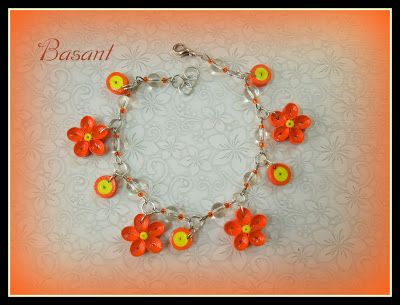 an orange bracelet with red flowers on it and the words basanit written in white