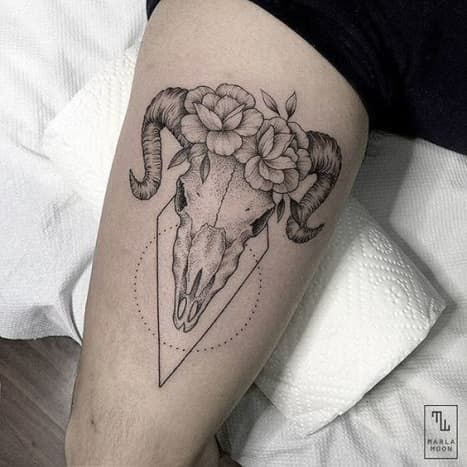 a goat skull with flowers on it's head and an arrow in the middle