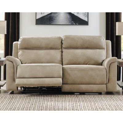 the reclining loveseat has two seats and is upholstered in beige leather