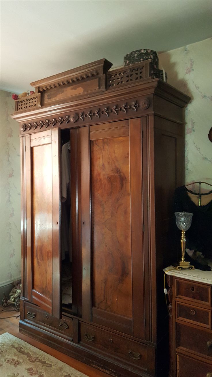 a large wooden armoire sitting on top of a hard wood floor