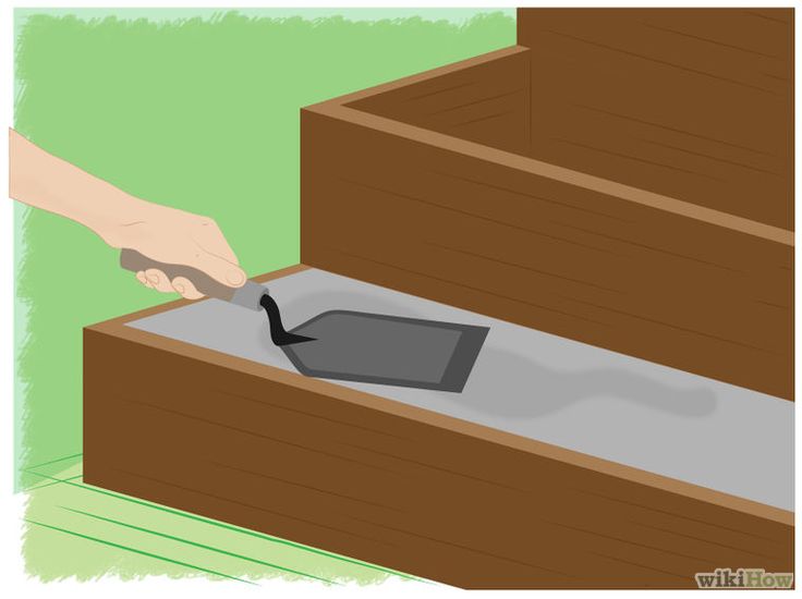 a person is opening a box with a black object in the bottom right hand corner