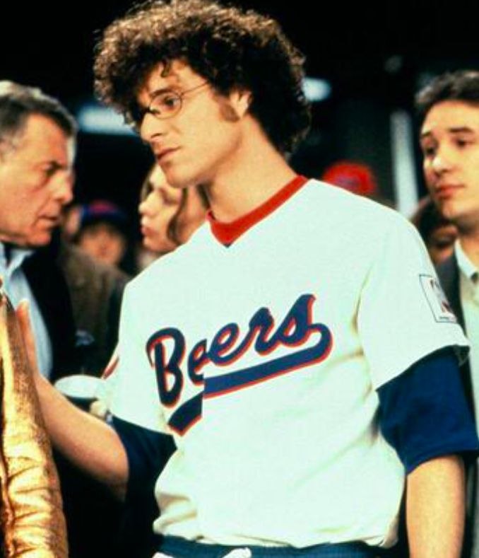 two men in baseball uniforms talking to each other