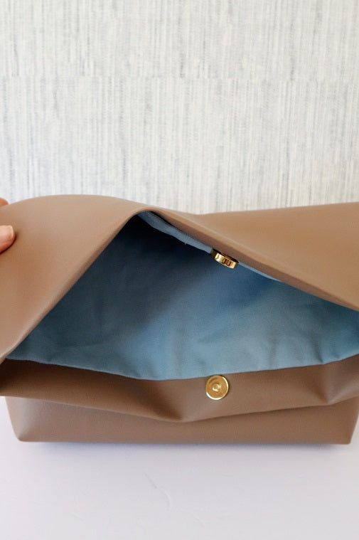 - Oversized fold clutch with wide base. - Sleek design.- Gold magnetic button closure. - Sky blue canvas interior. This clutch is a handmade item and the item pictured is the exact item you'll be purchasing. While I do duplicate some styles depending on popularity, they're usually never exactly the same. I hope this bag brings you as much joy carrying it, as it brought me creating it. Everyday Clutch Bag With Fold Over Clasp, Clutch Bag With Fold Over Clasp For Everyday Use, Everyday Clutch With Fold Over Clasp, Modern Clutch With Magnetic Closure For Daily Use, Travel Pouch Bag With Fold Over Clasp, Everyday Pouch Clutch With Magnetic Closure, Everyday Satchel Clutch With Magnetic Closure, Versatile Everyday Envelope Clutch, Versatile Envelope Clutch For Everyday