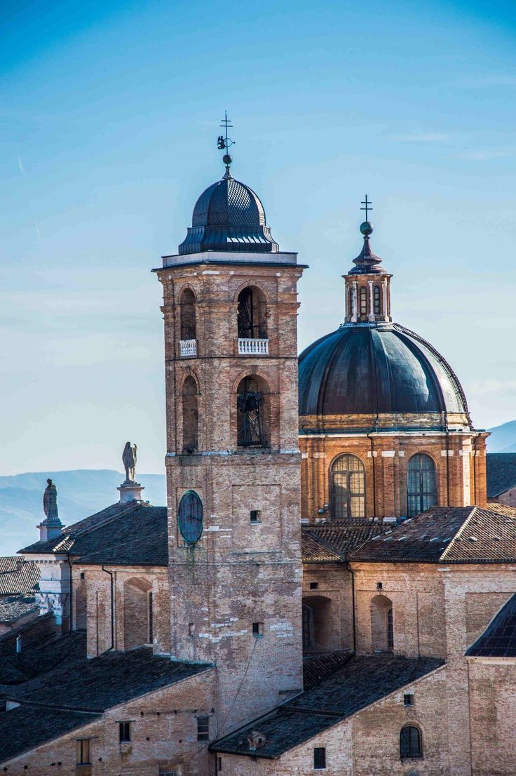 an old building with two towers and a bell tower