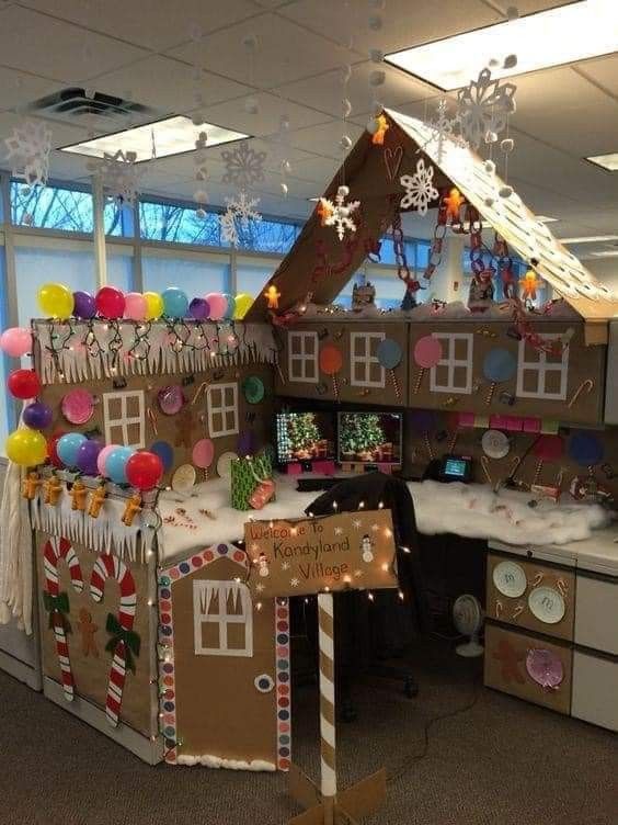 an office cubicle decorated with gingerbread house decorations