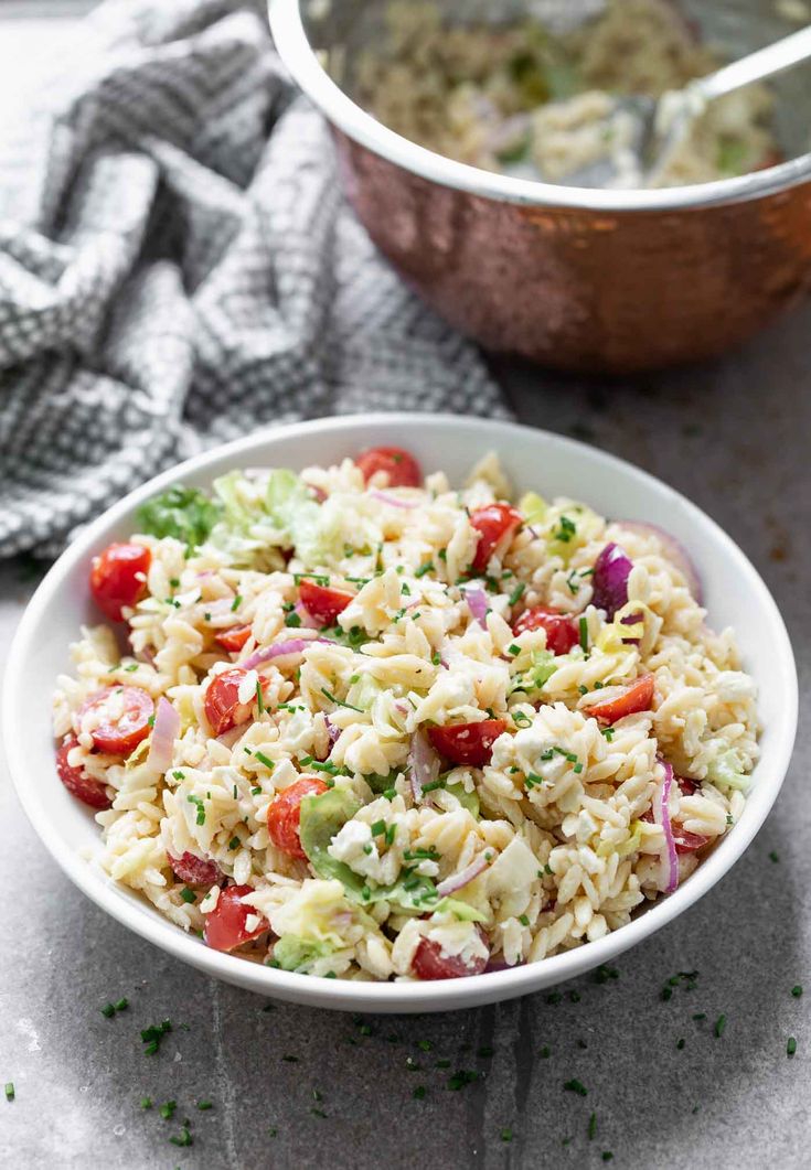 a white bowl filled with rice and vegetables