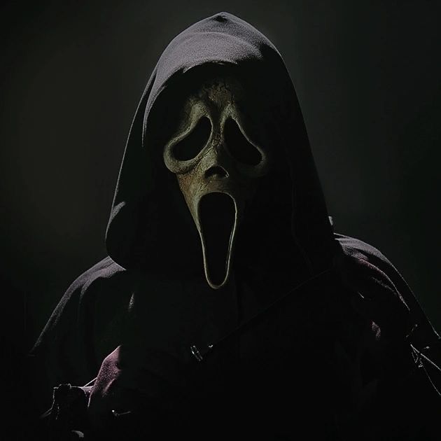 a man in a hooded costume with his mouth open