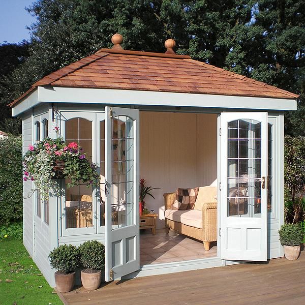 a wooden deck with a white and brown gazebo