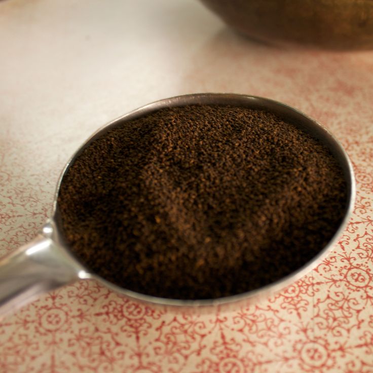 a scoop of ground coffee sitting on top of a table