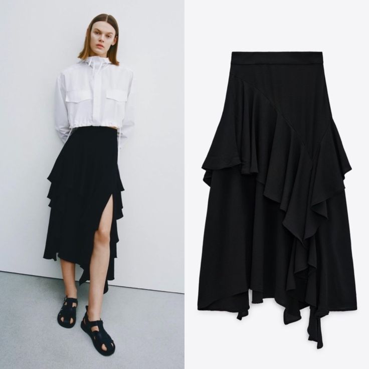 High-Waisted Midi Skirt. Tonal Matching Ruffles. Asymmetric Hem. Back Hidden In-Seam Zip Closure. Black Asymmetrical Hem Draped Skirt For Work, Black Draped Skirt With Asymmetrical Hem For Work, Chic Black Draped Skirt For Workwear, Chic Black Draped Skirt With Asymmetrical Hem, Black Asymmetrical Hem Skirt For Work, Chic Black Bottoms With Asymmetrical Hem, Chic Black Asymmetrical Draped Skirt, Black Asymmetrical Skirt For Spring, Spring Asymmetrical Hem Maxi Skirt With Ruffles