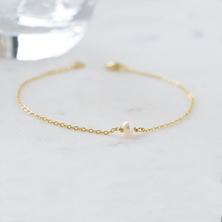 A beautiful and elegant dainty freshwater pearl bracelet. This bracelet is great for stacking or worn on its own for a delicate and minimalist look! Also makes a great gift for bridesmaids! Made of 925 Sterling Silver THICK plating of 14k Gold or Rhodium for a piece that is made to last! Available in 6.25" or 6.75" + .5" extension chain Made of freshwater pearls Nickel-free & Hypoallergenic Pearl Size: 3.5mm Lobster Clasp Closure Minimalist Sterling Silver Pearl Chain Bracelet, Minimalist Sterling Silver Pearl Bracelet With Charm, Dainty Sterling Silver Bracelets With Pearl Charm, Dainty Sterling Silver Pearl Bracelet With Charm, Everyday Delicate Sterling Silver Pearl Bracelet, Minimalist Sterling Silver Pearl Bracelet, Minimalist Sterling Silver Pearl Bracelet For Wedding, Minimalist Sterling Silver Bracelets For Bridesmaids, Dainty Sterling Silver Pearl Drop Bracelet