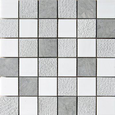 a white and grey tile wall with squares