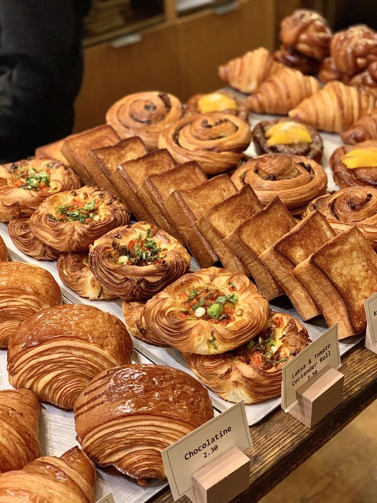 many different types of pastries are on display