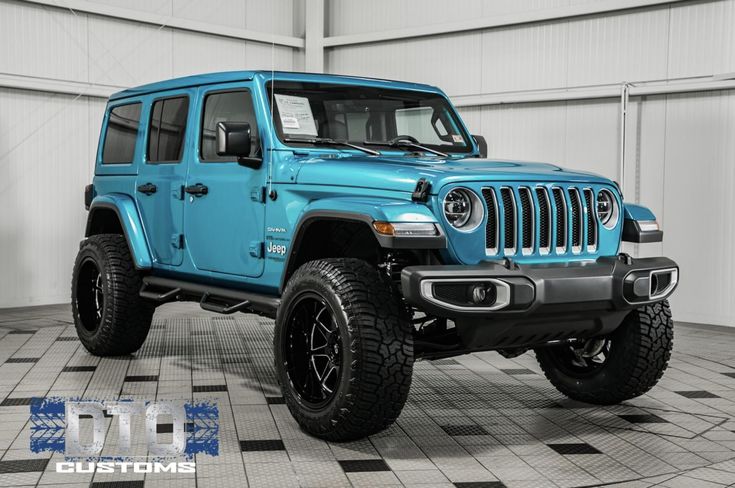 a blue jeep is parked in a garage