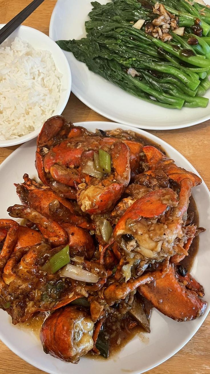 two white plates with cooked crabs and rice