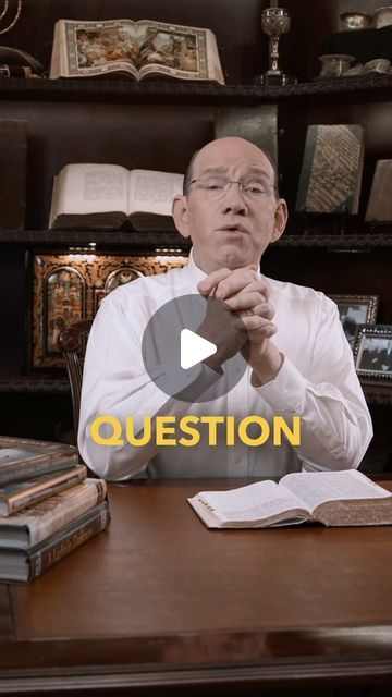 a man sitting at a desk with an open book in front of him and the words question