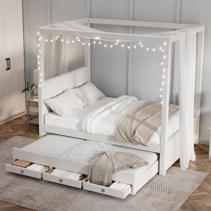 a white bed with lights on the headboard and foot board is in a room