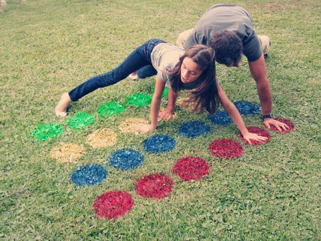 two people laying on the ground in front of some colored circles and letters that spell out numbers