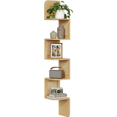 three wooden shelves with plants and pictures on them, one shelf has a potted plant in it