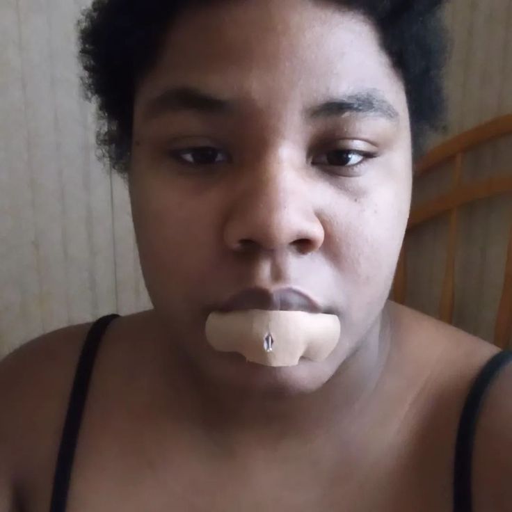 a woman with an object in her mouth