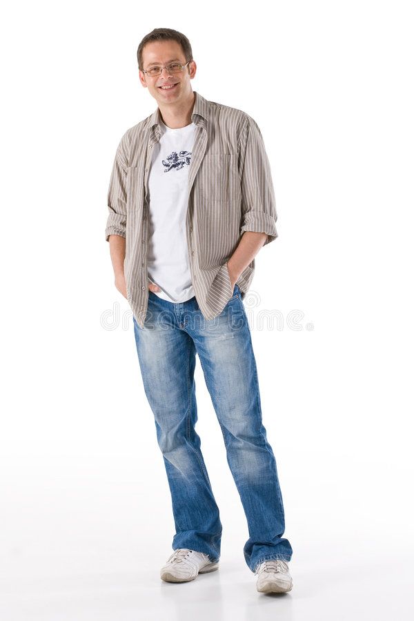 a man standing with his hands in his pockets and smiling at the camera royalty images