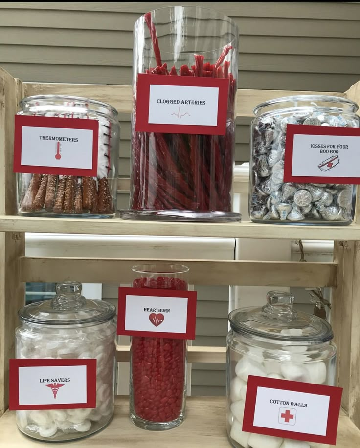 some jars filled with candy canes and candies on a shelf in a store