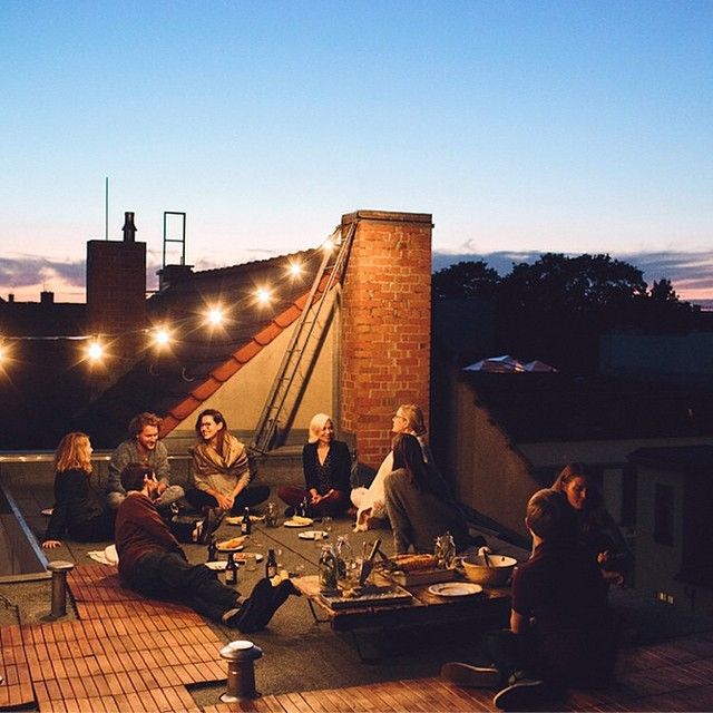 a group of people sitting on top of a roof