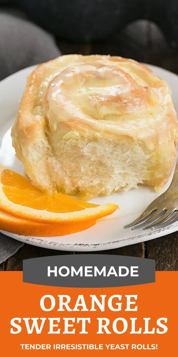 orange sweet rolls on a white plate with an orange slice