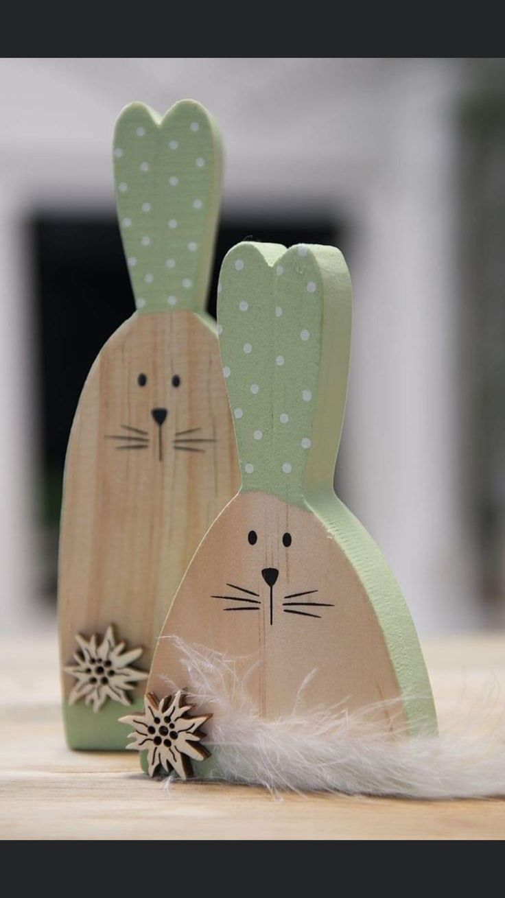 two wooden rabbits sitting next to each other