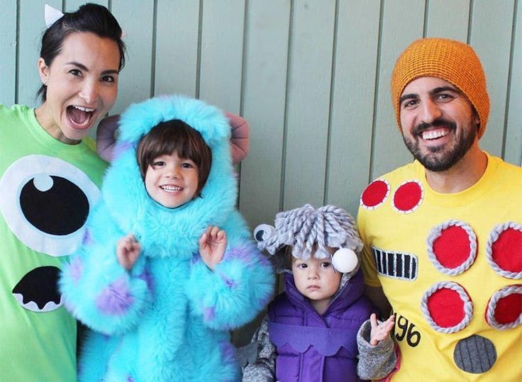 three adults and two children dressed up in costumes