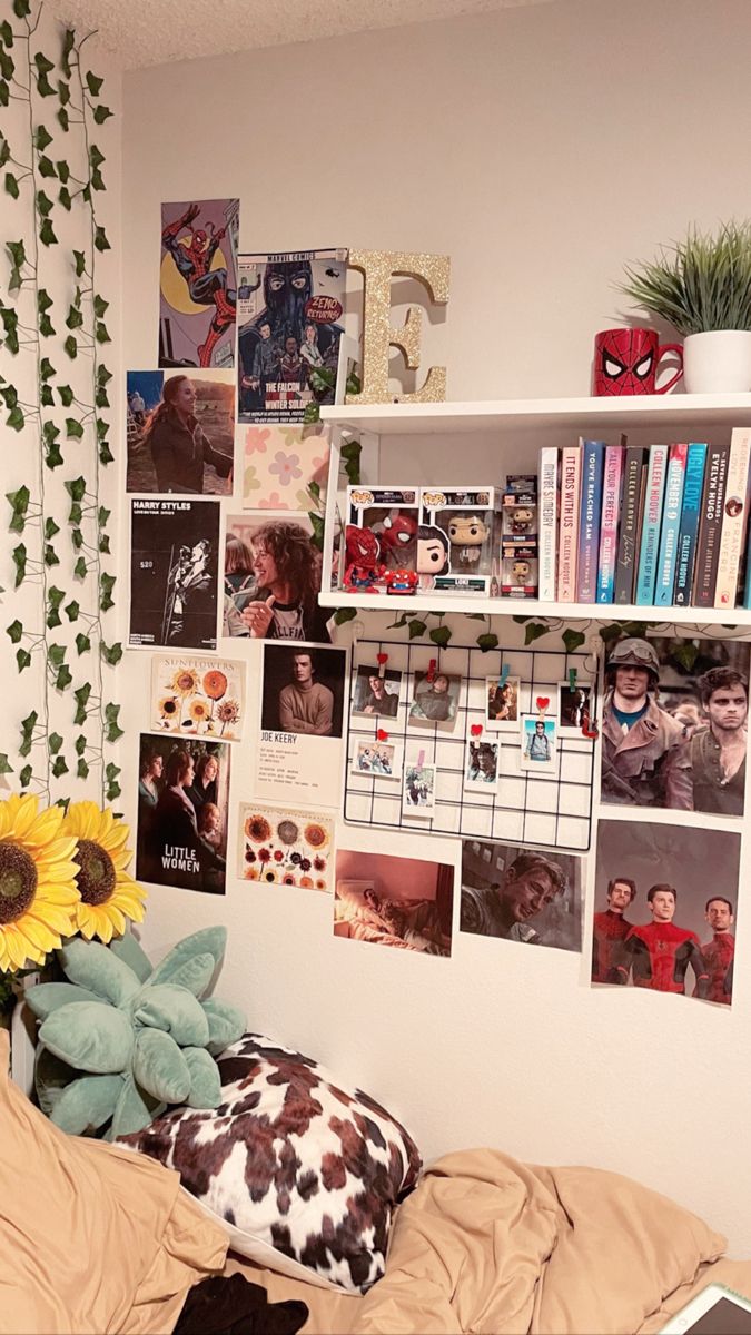 a bedroom with pictures on the wall and a sunflower sitting on top of a bed