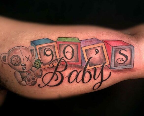 a baby's tattoo with blocks and a teddy bear