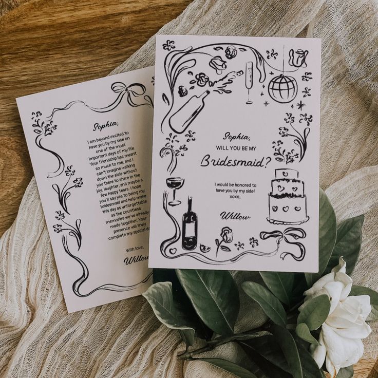 two wedding programs on top of a table with flowers and greenery next to them