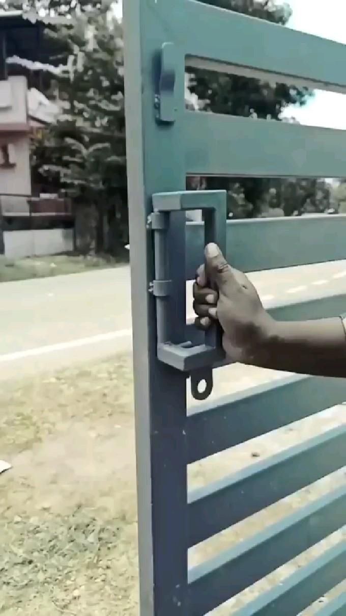 a person is opening the gate with their hand