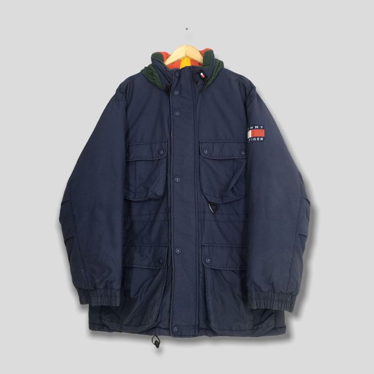 "Vintage Tommy Hilfiger Puffer Parka Jacket XLarge Tommy Hilfiger Sailing Gear Bomber Jacket Tommy Winter Wear Skiing Cold Weather Jacket XL Please contact me for any questions about this clothing before buying. Size on tag : Size XL Measurement : Armpit to armpit : 25\" inches Back collar to hem (total length) : 33\" inches Weight : 1.54 kg Condition : Good Condition. No holes and stains.  Delivery / Postage :- DHL EXPRESS / EXPEDITED = 3-5 business day. ** WE ARE USING DHL EXPRESS, IT TAKES 3- Sporty Winter Outerwear For Hiking, Sporty Outerwear For Winter Hiking, Casual Weatherproof Hooded Jacket For Winter Sports, Winter Parka For Outdoor With Long Sleeves, Urban Weatherproof Outerwear For Winter Sports, Winter Utility Sport Coat For Cold Weather, Casual Weatherproof Windbreaker For Winter Sports, Functional Navy Outerwear For Cold Weather, Hooded Jacket With Pockets For Winter Sports