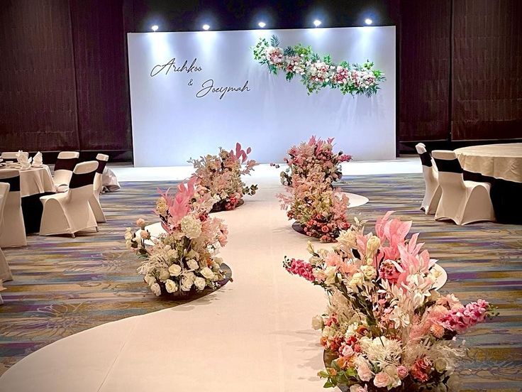 a banquet hall decorated with flowers and tables