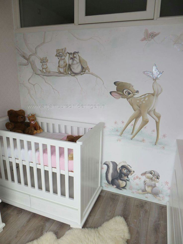 a baby's room with a deer mural on the wall