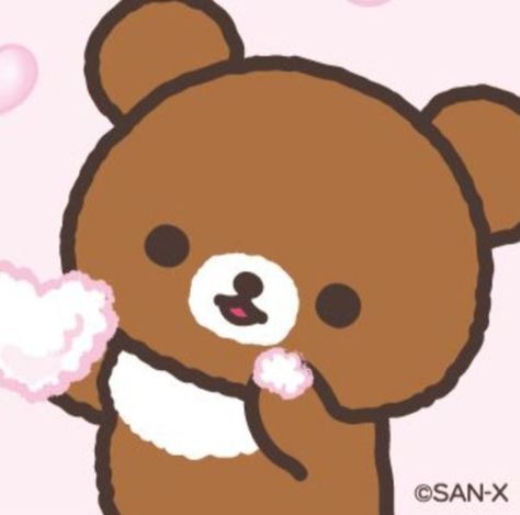 a brown teddy bear holding something in its mouth