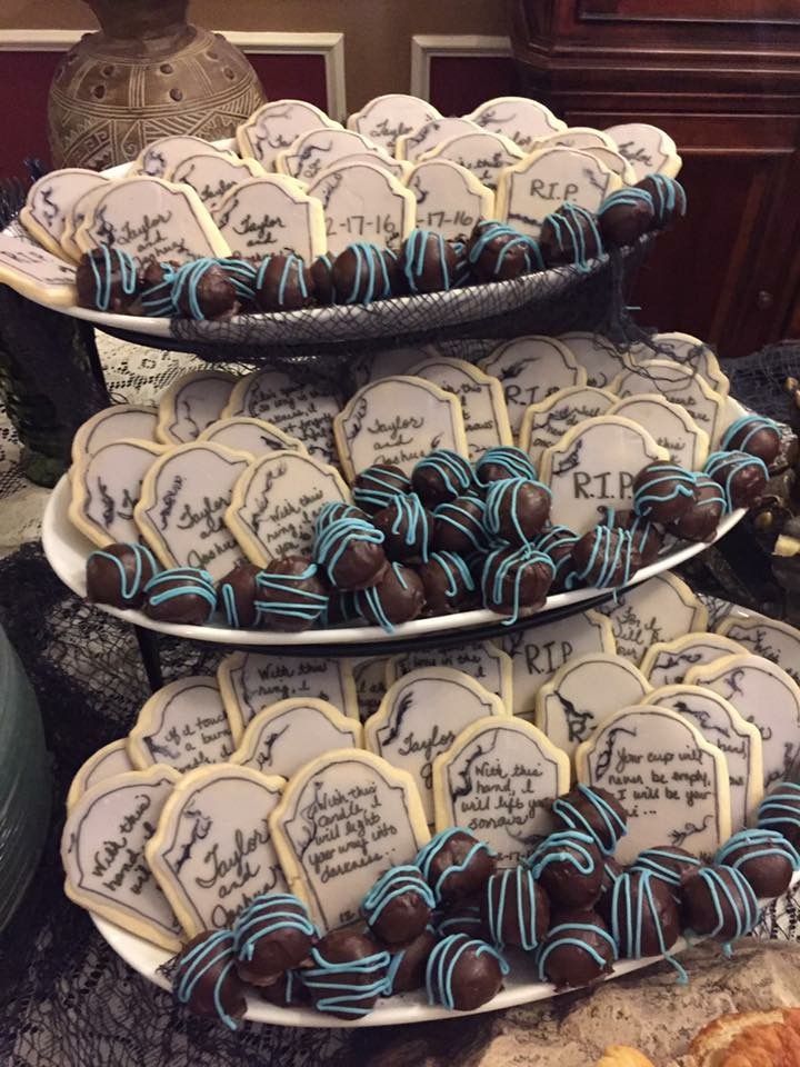 three tiered trays filled with cookies on top of a table covered in pastries