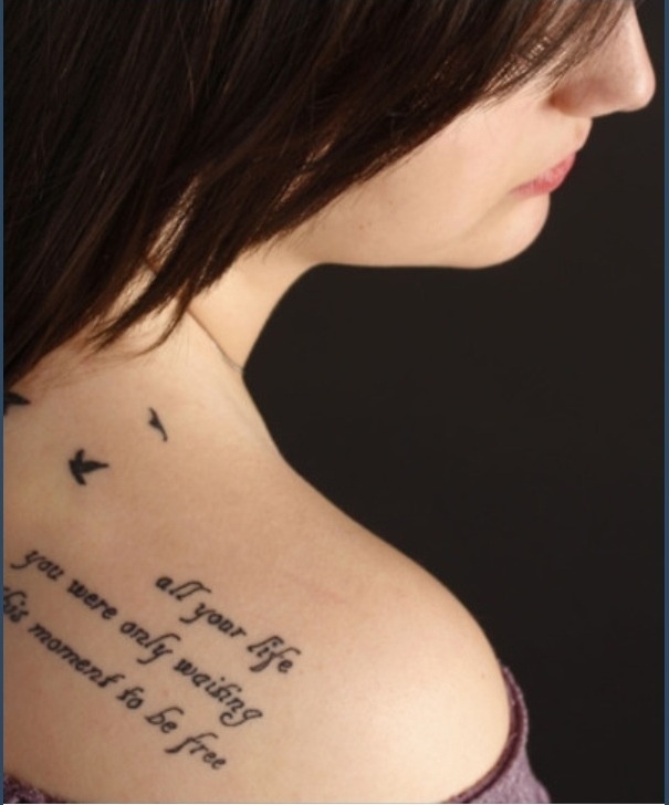 the back of a woman's shoulder with an inscription on it that reads,