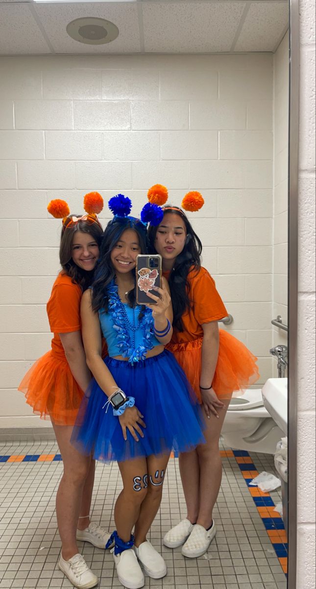 school spirit week, orange school spirit, blue school spirit, friday night lights football, color wars, color tutus, pom pom head bands, mirror picture #schoolspirit #blueout #orangeout #fridaynightlights #football #tutu Red Out School Spirit, Orange And Blue Spirit Day Ideas, Orange And Blue Football Outfit, Blue Color Wars Outfit, Class Color Day Spirit Week Outfits, School Pride Outfit Ideas, Spirit Makeup Football, Blue Out Spirit Day, Class Color Day Spirit Week Blue