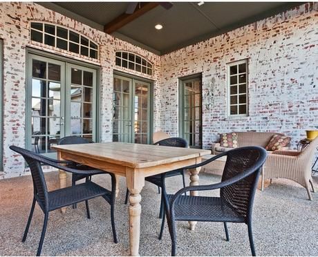 a table and chairs are on the outside patio with sliding glass doors that lead to an outdoor living area