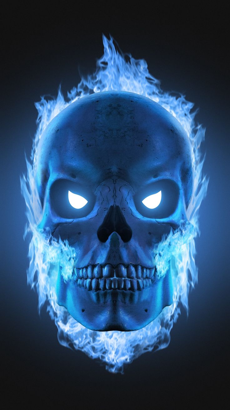 a blue skull with glowing eyes and flames on it's face in the dark