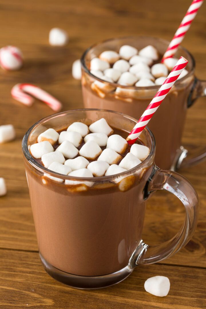 two mugs filled with hot chocolate and marshmallows