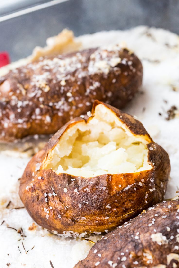 two baked potatoes sitting on top of a table