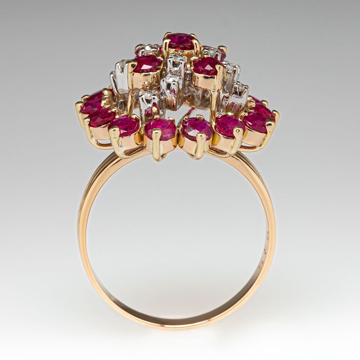 This beautiful cluster cocktail ring is three-prong set with nineteen (19) round mixed cut rubies. The top of the ring is accented with twelve (12) round single cut diamonds, in four-prong settings. The ring measures 19.8mm at the top, rises 11.5mm above the finger, tapering to 2.2mm wide and 0.7mm thick at the base of the shank. This ring is currently a size 8.25. Formal Ruby Ring With Diamond Accents In Cluster Shape, Red Cluster Diamond Ring With Brilliant Cut, Formal Cluster Ruby Ring With Diamond Accents, Ruby Ring With Diamond Cluster And Brilliant Cut, Cluster Ruby Ring With Brilliant Cut Diamonds, Diamond Cluster Ruby Ring With Diamond Accents, Ruby Cluster Diamond Ring, Classic Ruby Ring With Rose Cut Diamond Cluster, Fine Jewelry Ruby Cluster Ring With Brilliant Cut