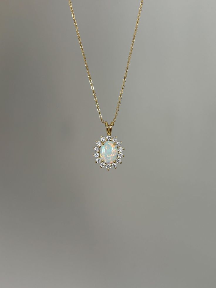 One of my personal favorites, this opal necklace is a must-have! Information: ✨ Simulated Opal Gemstone | High Quality ✨ Sterling Silver (925 stamped) | 14K Gold Plated ✨ AAA Cubic Zirconia diamonds ✨ Adjustable length: 16" - 18" ✨ Hypoallergenic  ✨ Tarnish resistant A classic, this necklace is the perfect addition to you collection - it holds a beautiful sophisticated vibe that upgrades your outfit instantly. Personally, I wear this piece quite often and the sparkles are so strong that I am alw Formal Opal Round Necklace, Formal Round Opal Necklace, Delicate Opal Gemstone Necklaces, Opal Round Pendant Necklace For Anniversary, Dainty Opal Pendant Necklace, Dainty Round Opal Necklace, Oval Opal Necklace For Anniversary, Anniversary Opal Round Pendant Necklace, Anniversary Opal Necklace With Round Pendant