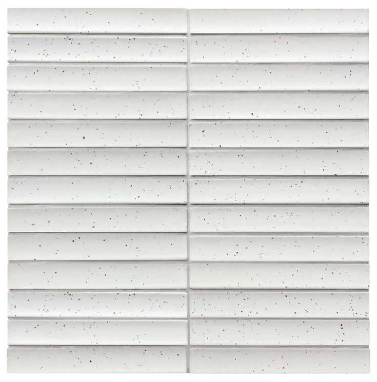 a white tile wall with black speckles on the top and bottom part of it