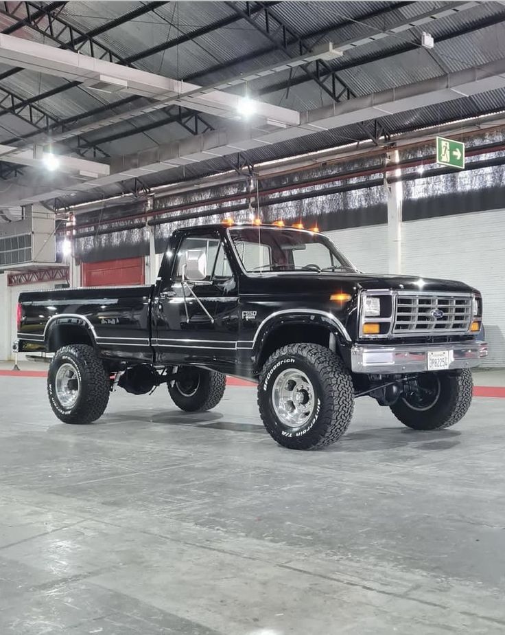 a large black truck parked in a garage