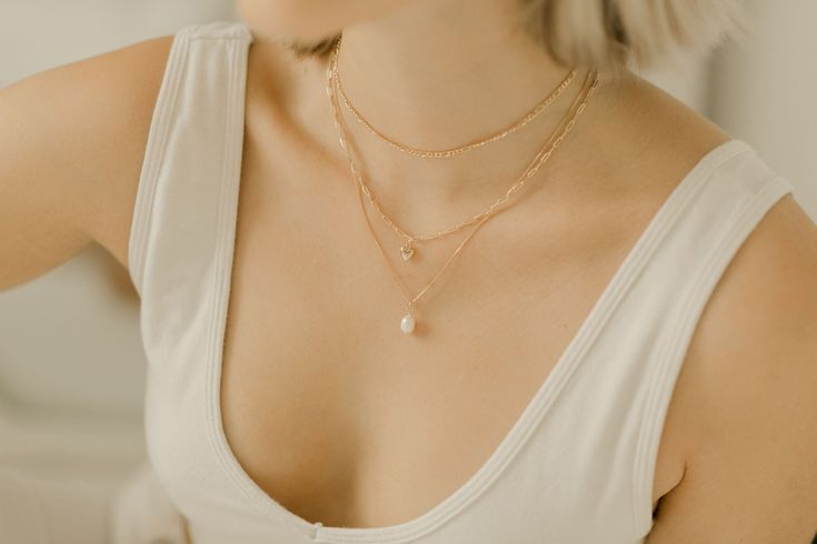 Add a touch of sweetness to your jewelry collection with this dainty heart pendant necklace. The gold-filled paperclip chain offers a modern twist on the traditional heart pendant design. Whether you're dressing up or keeping it casual, this necklace is the perfect finishing touch to any outfit The Chain Details:18k Gold FilledDainty Heart Pendant Hypoallergenic (lead + nickel free) ∙ G O L D ∙ F I L L E D ∙ Gold-filled components contain 100+ times more real gold than gold-plated components and Delicate 14k Gold Filled Paperclip Chain Jewelry, Delicate 14k Gold-filled Paperclip Chain Jewelry, Simple Paperclip Chain Necklace As Gift, Simple Paperclip Chain Necklace Gift, Elegant Everyday Charm Necklaces With Paperclip Chain, Elegant Paperclip Charm Necklaces For Everyday, Delicate Paperclip Chain Necklace For Gift, Elegant Heart Shaped Figaro Chain Necklace, Elegant Heart-shaped Figaro Chain Necklace